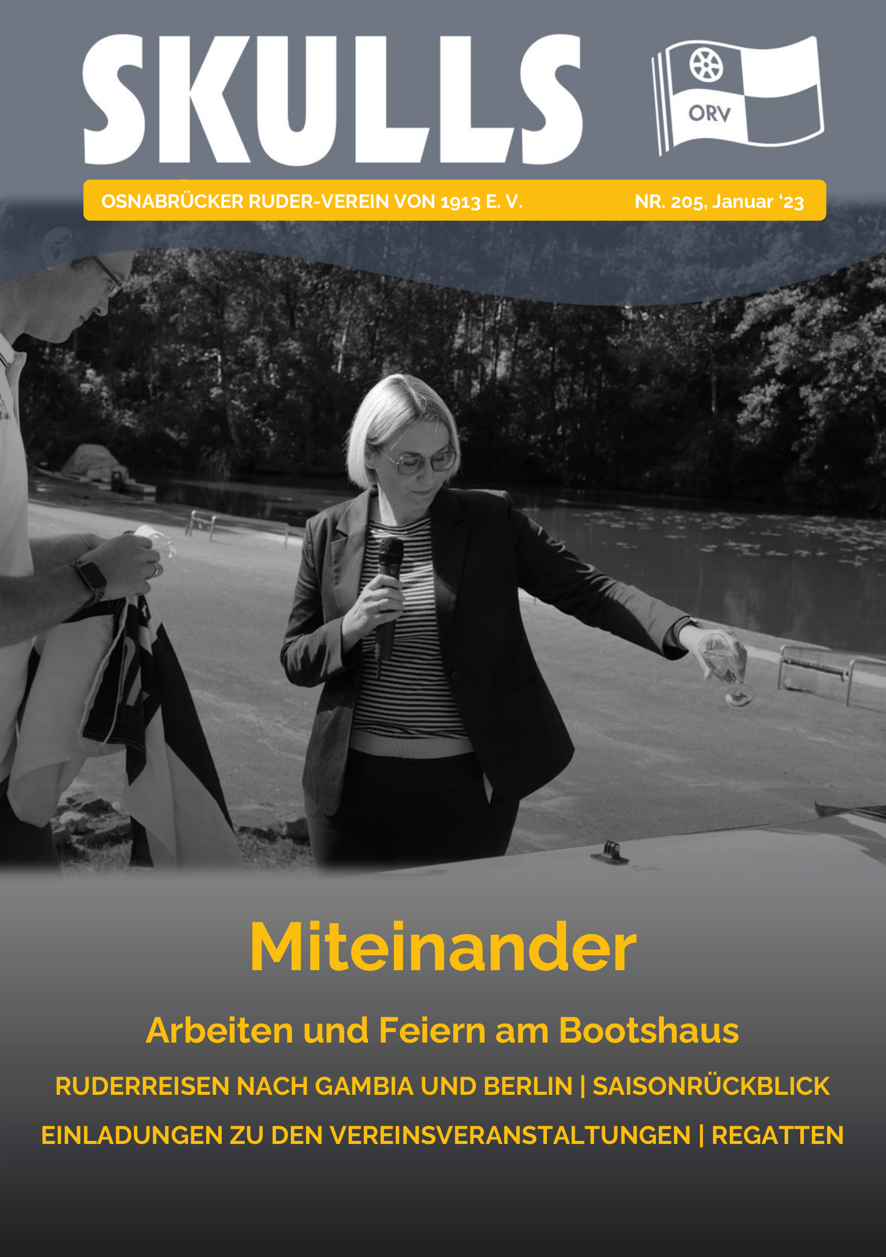 Das Magazin-Cover zeigt zwei Personen bei einer feierlichen Ansprache am Wasser, in Schwarz-Weiß gehalten.